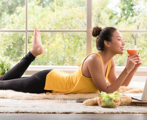 woman laying down drinking beverage