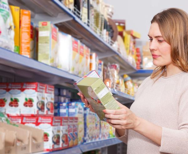 woman looking at cereal in store