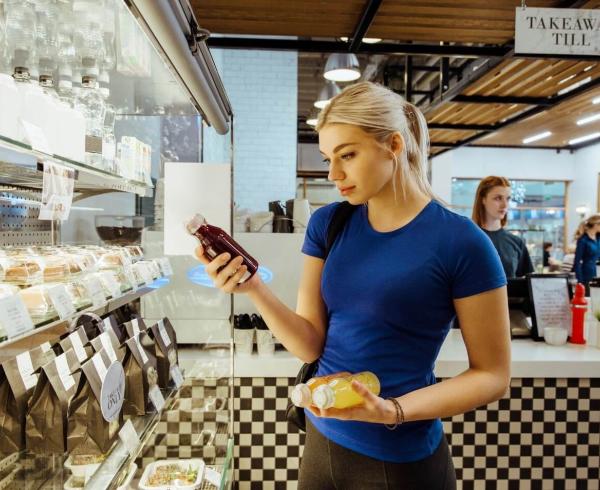 woman looking at juice in store