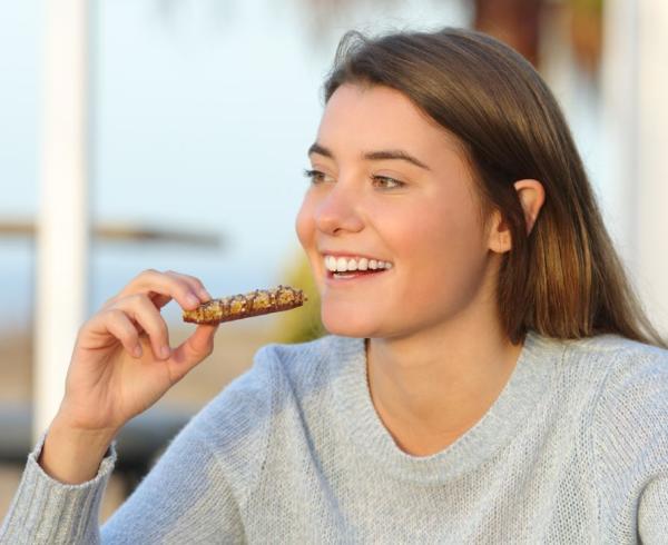 woman with nutritious bar